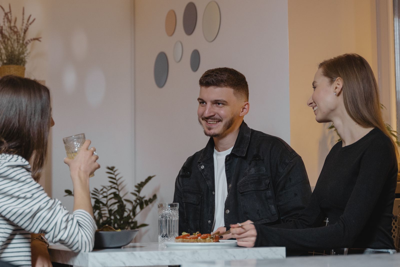 Friends enjoying a meal and conversation in a restaurant — illustrative stock photograph